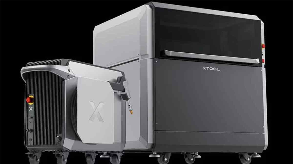 Two modern 3D printers on a black background.